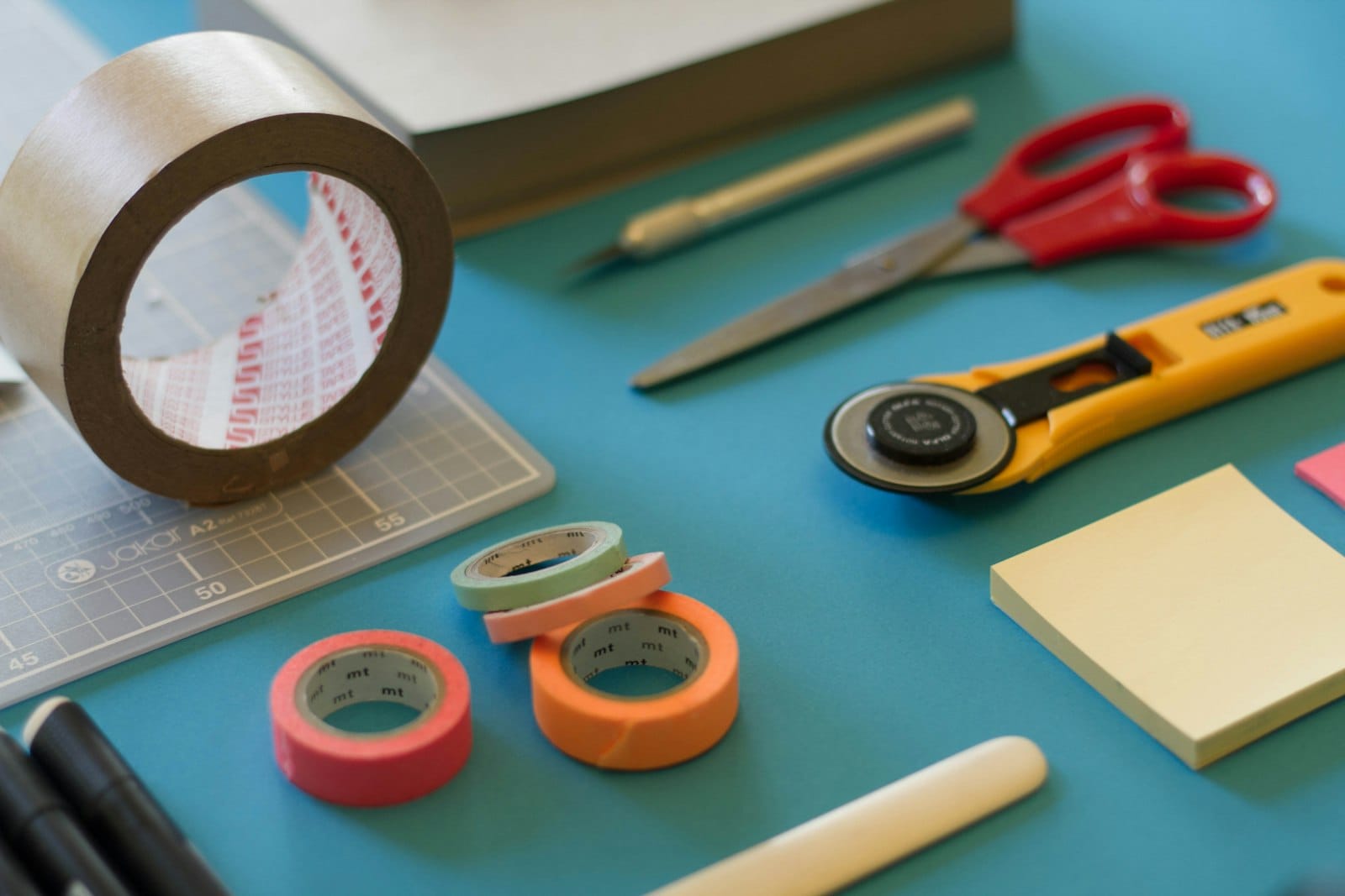 Handmade objects arranged on a workbench in low light
